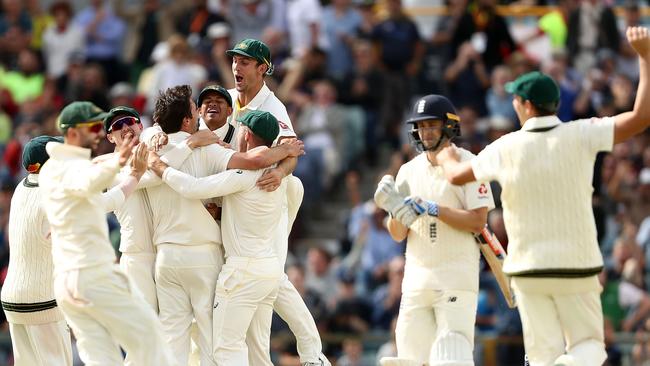 Ausralia celebrate after Pat Cummins claimed the final wicket of Chris Woakes.