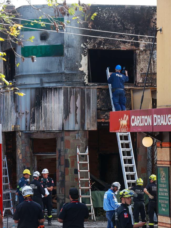 Police and firefighters at the fire scene on Tuesday. Picture: Justin Lloyd