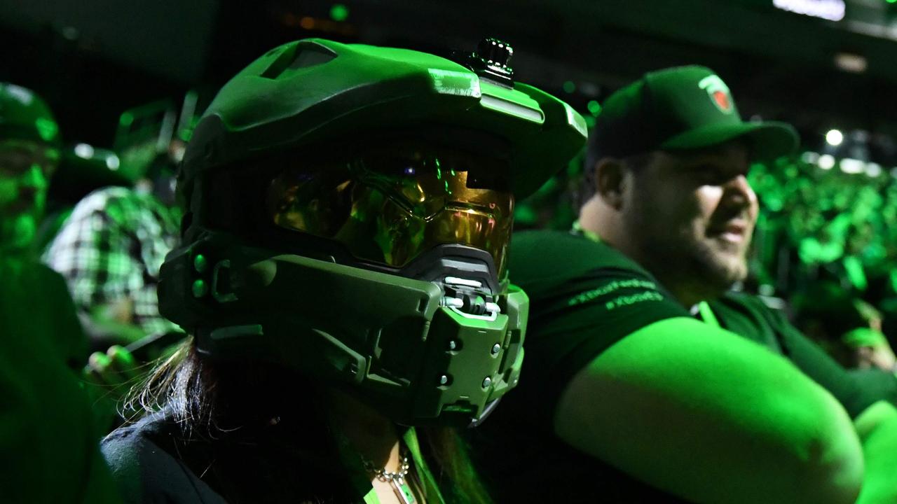 An attendee wears the helmet of Master Chief from the original Halo at a 2017 Microsoft event. Picture: Robyn Beck/AFP