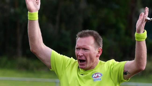 Veteran local umpire Sean Lowe in his 500th match.