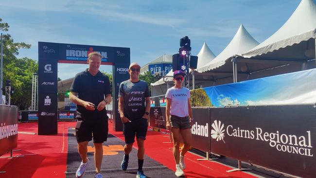 Group Oceania managing director Geoff Meyer with past Cairns Ironman winner Brad Currie and Sarah Crowley at the finish line for the Ironman Cairns. Picture: Harry Murtough