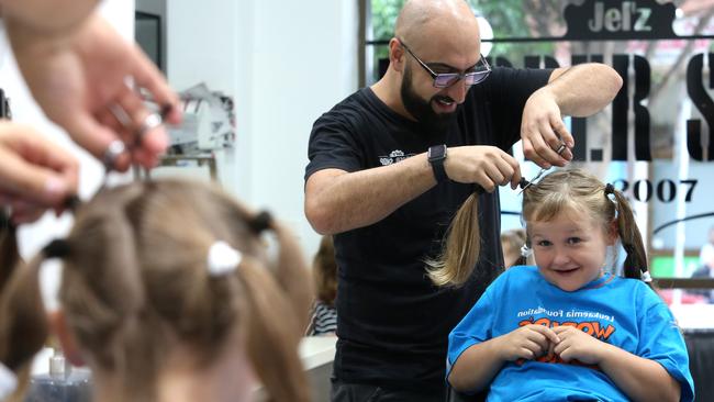 Jel’z Barber Shop owner Michael Nagi begins cutting Cooper Pamment’s hair. Picture: Rob Pozo