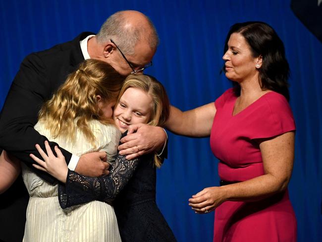 Scott Morrison hugs daughters Abbey (L) and Lily (2nd R) with wife Jenny Morrison (R) after the Liberal Party's campaign launch in Melbourne in 2019. Picture: William West/AFP