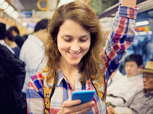 Subway train jorney - Stock imageCaucasian Ethnicity, Reading, Smiling, Text Messaging, Tokyo - Japan. Picture: iStock