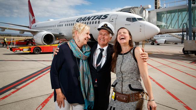 Qantas pilot Captain Rick Paul with his wife Claudia and daughter Kristie after he touched down on his final flight. Picture: Matt Turner