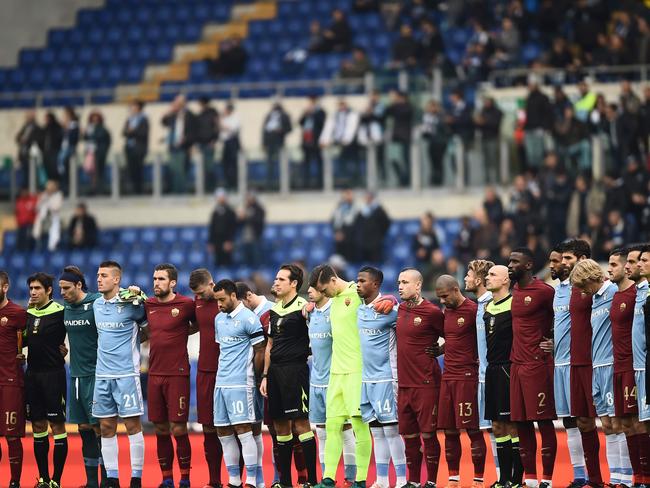 Players and referees stand together to pay tribute to Brazilian football team Chapecoense which was wiped out in the crash. Picture: Filippo Monteforte/AFP