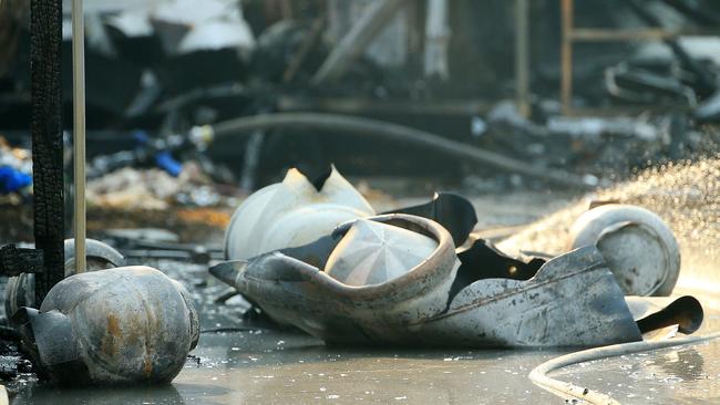 An illegal home-based food business caused a series of huge gas bottle explosions that started a bushfire, destroyed a home and burnt out cars.