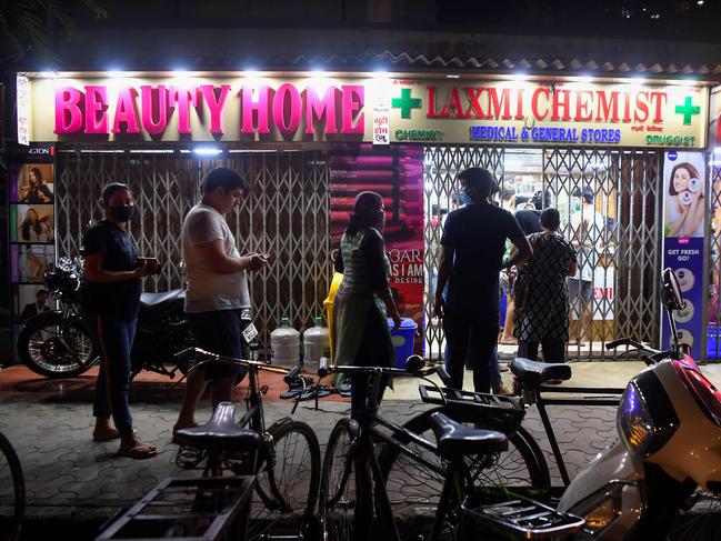 People in Mumbai line up outside a store to buy supplies following news India would enter a 21-day lockdown. Picture: AFP