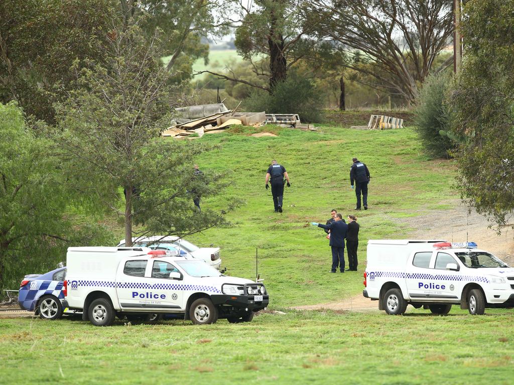 Police investigating the murder, a day after the bodies were found. Picture: Tait Schmaal