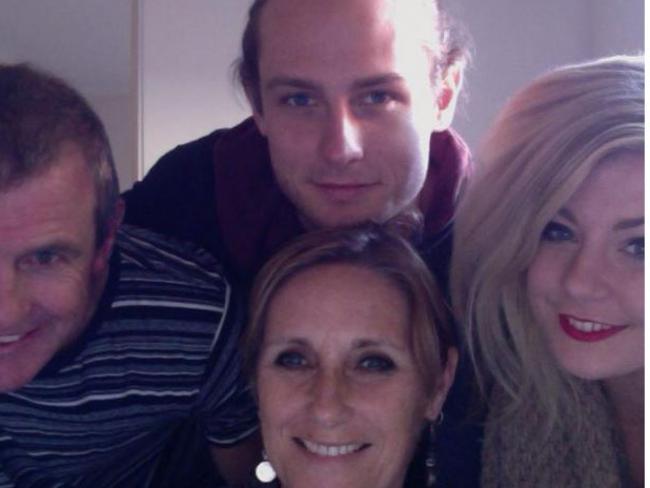 Phil Walsh with his wife and children, including Cy (top).