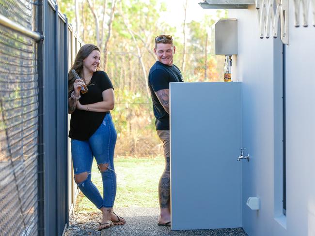 Zuccoli home owner Jarrett Sherman enjoys his new outdoor loo after making a deal with his wife Shay. Picture: Glenn Campbell