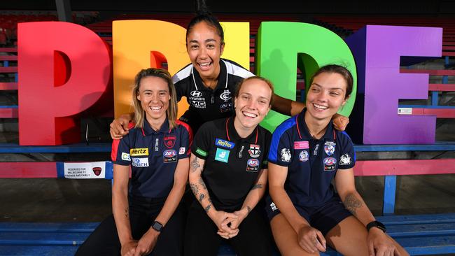 Darcy Vescio (back) with (L-R) Aliesha Newman, Tilly Lucas-Rodd and Ellie Blackburn as they celebrate Pride Round in AFLW.