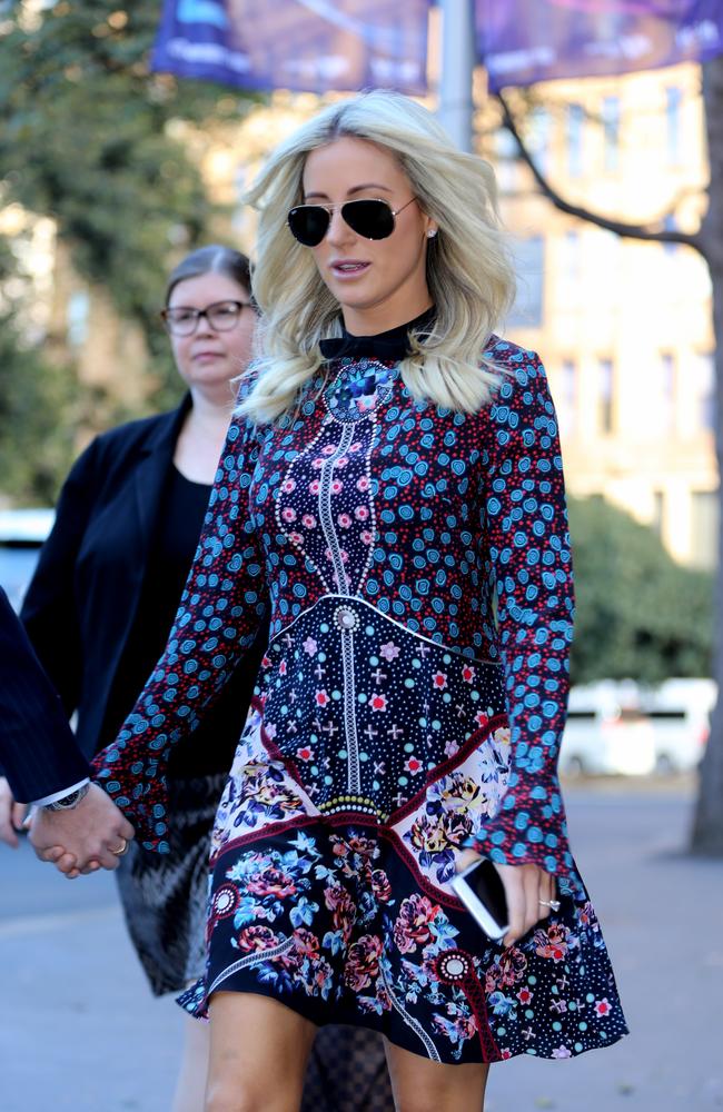 Roxy Jacenko wears two-piece and Louis Vuitton belt supporting husband  Oliver Curtis at court