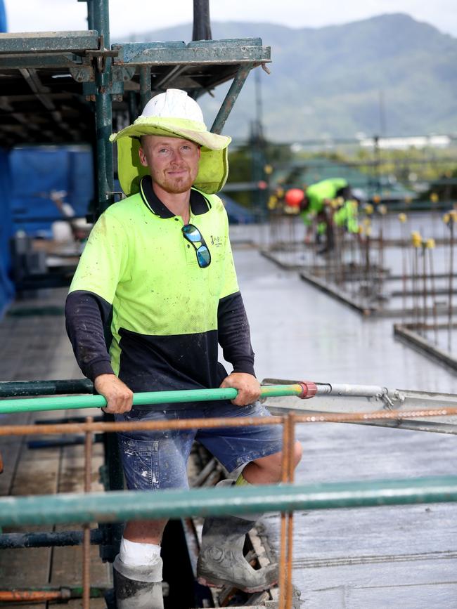 Last year Bryant Building Contractors began work on 42 single-bedroom units under a state government social housing contract. Form worker Trent Denman smoothing out the roof of the building during a concrete pour. PICTURE: STEWART McLEAN