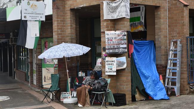 Metal gates prevent entry to Anthony Albanese's electorate office but the lights are on. Picture: Noah Yim