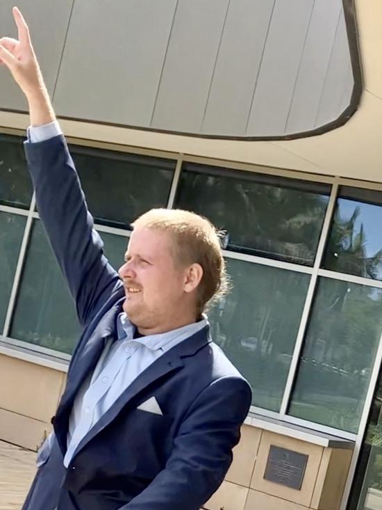 Daniel Russell raised his hand as he left Coffs Harbour District Court on April 12, 2023