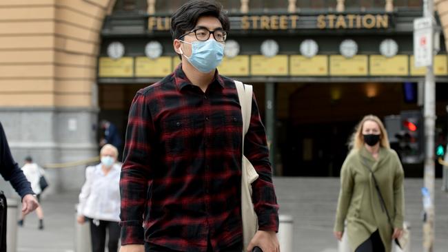 Morning commuters outside Flinders Street Station on Monday — the first day where 50 per cent of workers could return to the office. Picture: NCA NewsWire/Andrew Henshaw