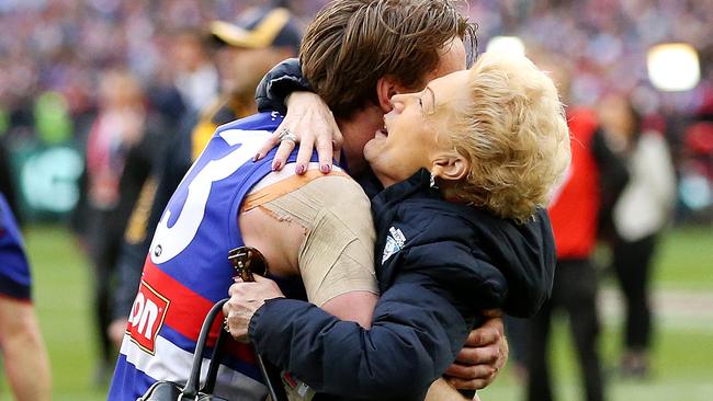 Vice-president Susan Alberti embraces Jordan Roughead on the ground after the win. Picture: Mark Stewart