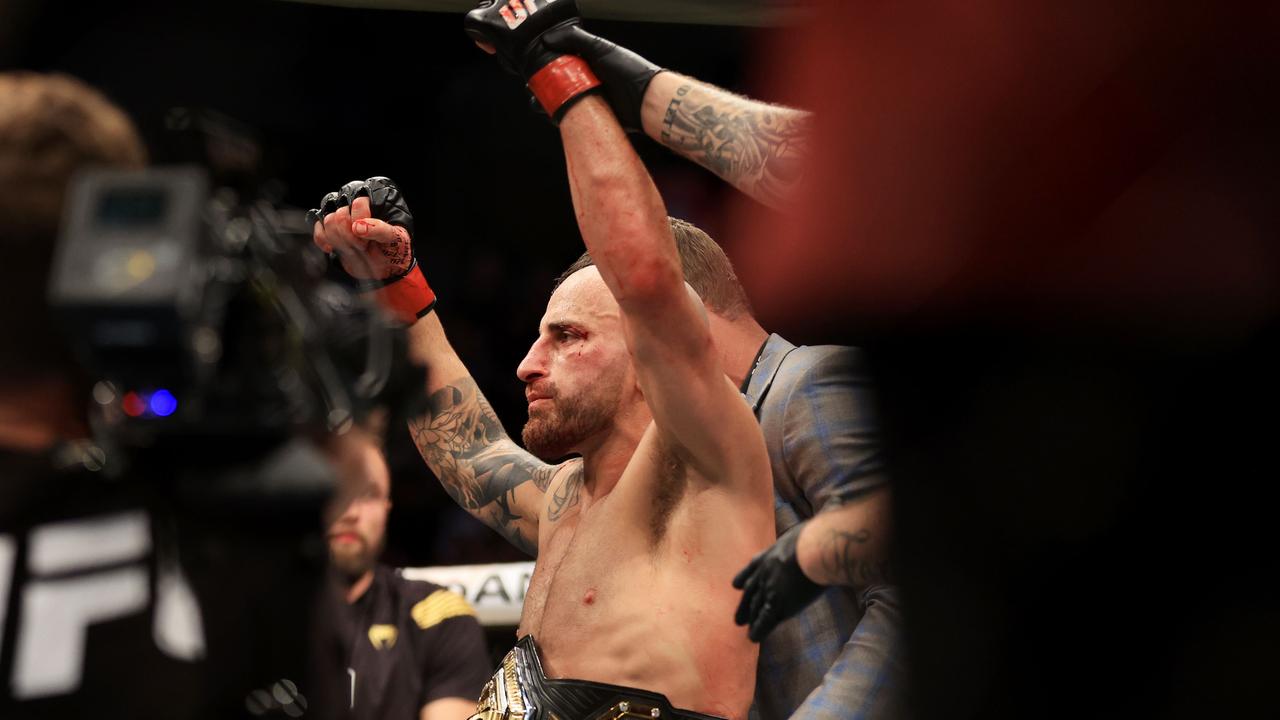 Alexander Volkanovski of Australia celebrates his unanimous decision win over Max Holloway in their featherweight title bout during UFC 276 at T-Mobile Arena.