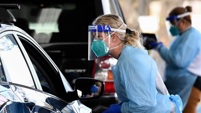 Health workers at the Fairfield Showground Sypath Drive-through Clinic. Picture: NCA NewsWire/Bianca De Marchi