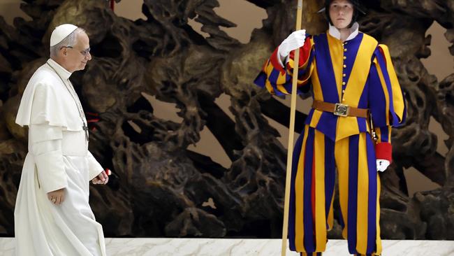 Pope Leo XIV walks past a Swiss guard inside the Vatican. Picture: Getty Images