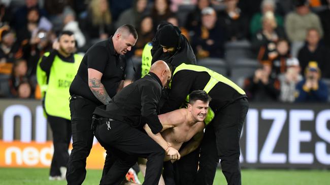 Security eventually caught up with the streaker. Picture: AAP