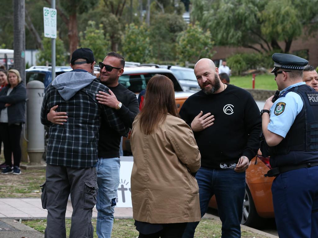 Protestors have begun to gather outside Kiis FM headquarters in North Ryde to protest against comments Kyle Sandilands made about Christians and the Virgin Mary. An ARN staffer (lady pictured in brown jacket) came and spoke to the protestors. Picture: David Swift.