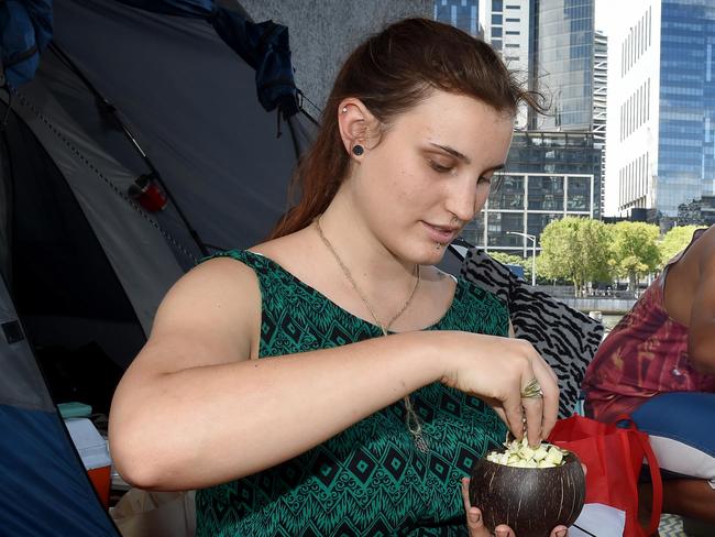 Selina, 22, cooks lunch on a camping stove set up at Enterprize Park. Selina is one of many genuine homeless people in Melbourne Picture: Nicole Garmston