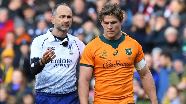 French referee Romain Poite (L) speaks with Australia's flanker Michael Hooper (R) during the Autumn International rugby union match between Scotland and Australia at Murrayfield Stadium in Edinburgh on November 7, 2021. (Photo by ANDY BUCHANAN / AFP)