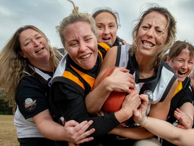 Mums from the Upwey Tecoma Tigers and the Belgrave Magpies getting ready to do battle to raise money for the family of Mum, Leanne Gorry, who recently died of cancer.Carrie Wallis (Magpies) with the ball gets caught by Anna Bianchi (Tigers). Picture: Jay Town