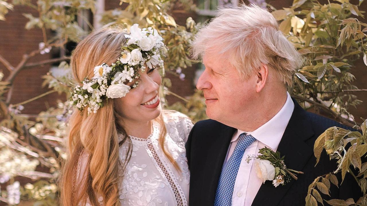 Boris Johnson poses with his wife Carrie Johnson in the garden of 10 Downing Street following their wedding at Westminster Cathedral. (Photo by Rebecca Fulton / Downing Street via Getty Images)