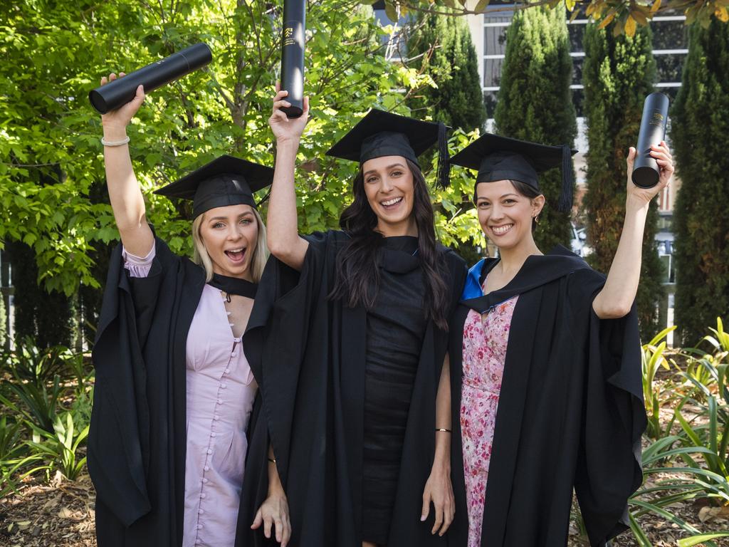 Bachelor of Nursing graduates (from left) Shenoa Trahair, Monique Crilly and Kate Osborne celebrate at a UniSQ graduation ceremony at Empire Theatres, Tuesday, October 31, 2023. Picture: Kevin Farmer