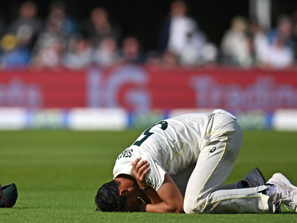 Mitch Starc clutches his shoulder on day three. Picture: Oli SCARFF / AFP.