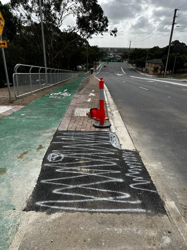 Changes have been made to the Flagstaff Rd, Darlington, bikeway blamed for the death last month of a cyclist. A concrete tripping hazard, pictured behind this warning cone, has been removed. Pictures: Frank Pangallo.,