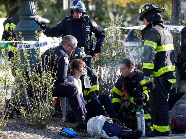 A woman is aided by first responders. Picture: Reuters