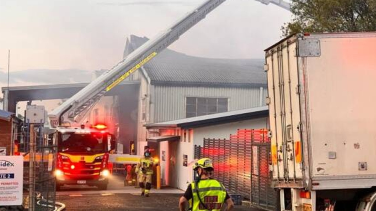 Smoke spews out of large factory blaze