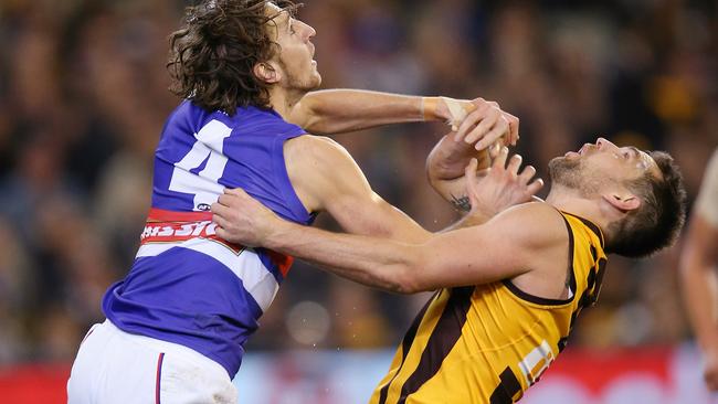 Marcus Bontempelli pushes Luke Hodge in a marking contest before taking the grab and kicking the goal. Picture: Michael Klein