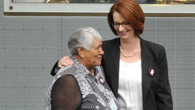 Then prime mnister Julia Gillard greets the first chair of the now defunct ATSIC Lowitja O’Donoghue after the Act of Recognition debate in Canberra in 2013. Picture: AAP Image/Alan Porritt