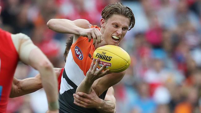 Lachie Whitfield gets a handball away during the qualifying final. Picture: Phil Hillyard