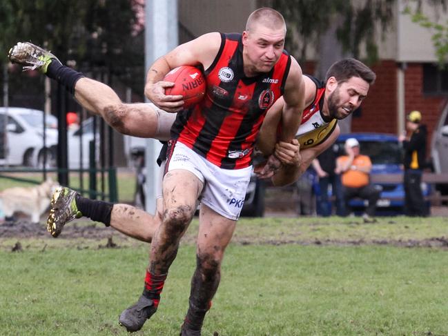 Rostrevor Old Collegians' (ROC) Will O'Malley shrugs his Goodwood Saints opponent in their Adelaide Footy League clash on Saturday. Picture: Jayson Vowles (MUST CREDIT)