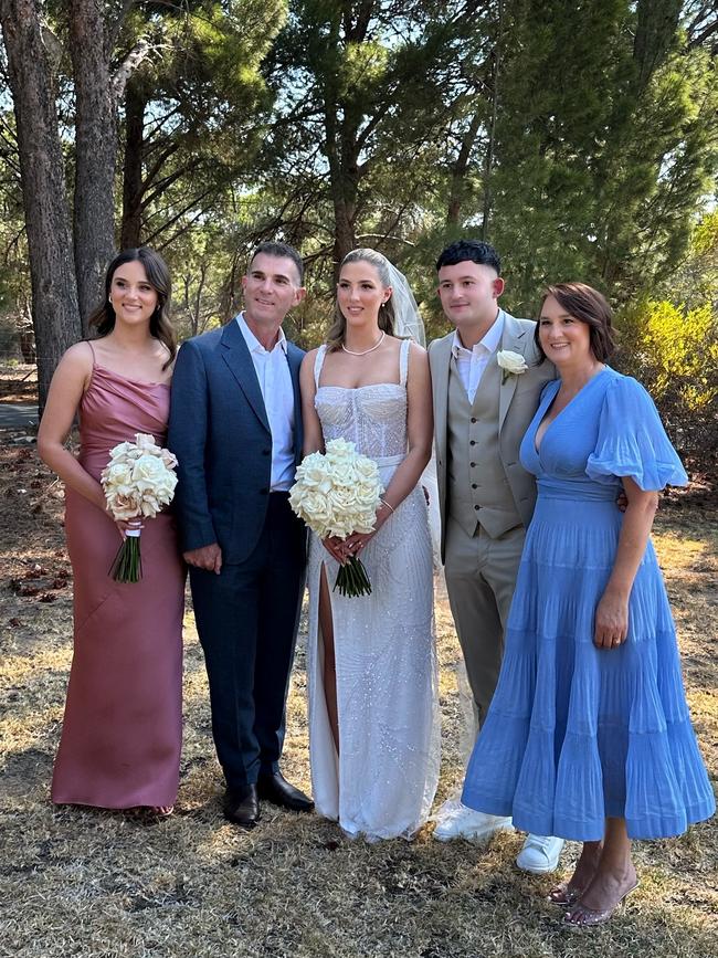 Kathryn with her two daughters Alayna (in white) and Kaylie (in pink), her son-in-law and husband Tony at Alayna’s wedding. Picture: Supplied