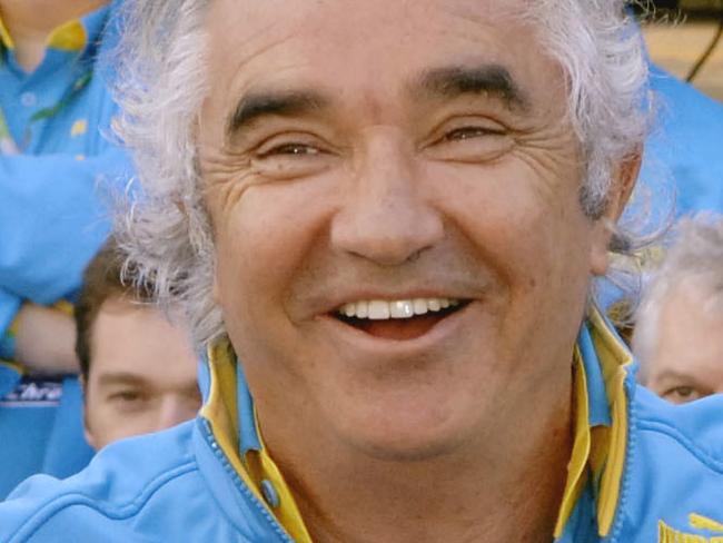 Renault F1 drivers Fernando Alonso (L) and Giancarlo Fisichella pose for a photograph with team members and team principal Flavio Briatore in their pit area prior to Australian Formula One Grand Prix at Albert Park in Melbourne 02/04/06.