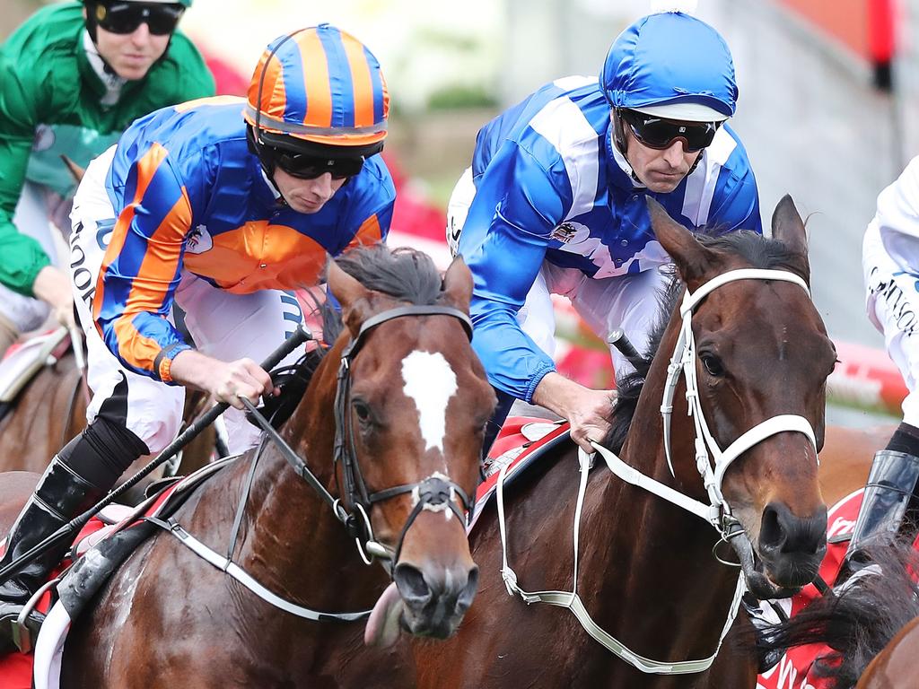 Hugh Bowman (in blue) rides Winx, boxed in next to Ryan Moore on Rostropovich, in race 9 the Ladbrokes Cox Plate during the 2018 Cox Plate Day at Moonee Valley Racecourse