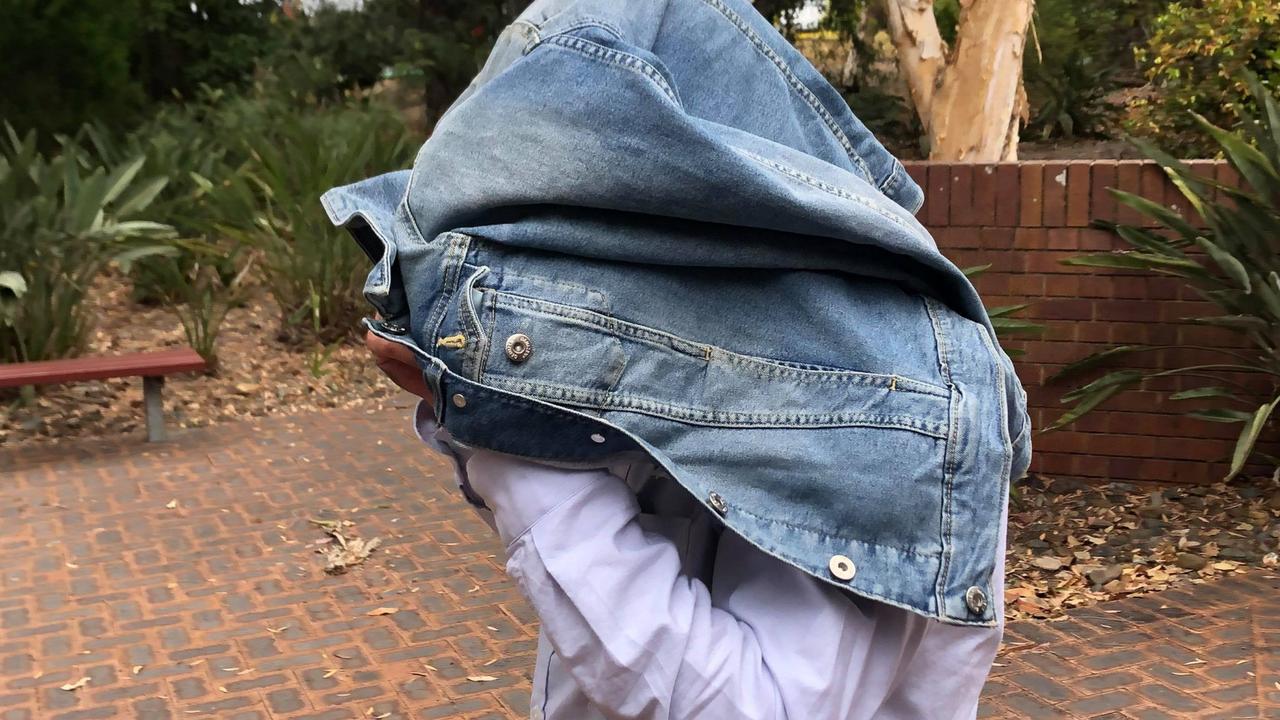 A 49-year-old child sex offender covered his face while leaving Noosa Magistrates Court on Tuesday. Picture: Laura Pettigrew.