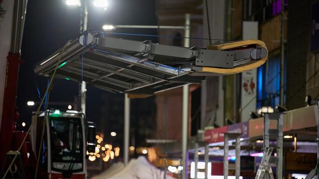 The canopy is lifted into place along Church St, Parramatta.