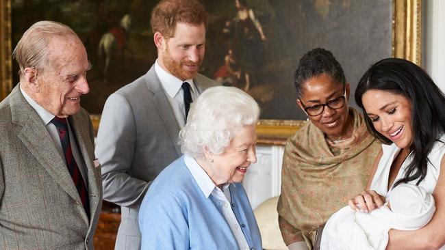 Prince Harry, Duke of Sussex and Meghan, Duchess of Sussex are joined by her mother, Doria Ragland, as they show their new son, Archie Harrison Mountbatten-Windsor, to the Queen Elizabeth II and Prince Philip, in 2019 in Windsor.