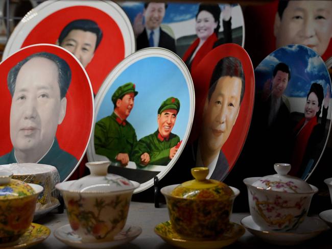 Decorative plates featuring images of Xi Jinping and Mao Zedong are displayed at a shop in Beijing. Picture: AFP