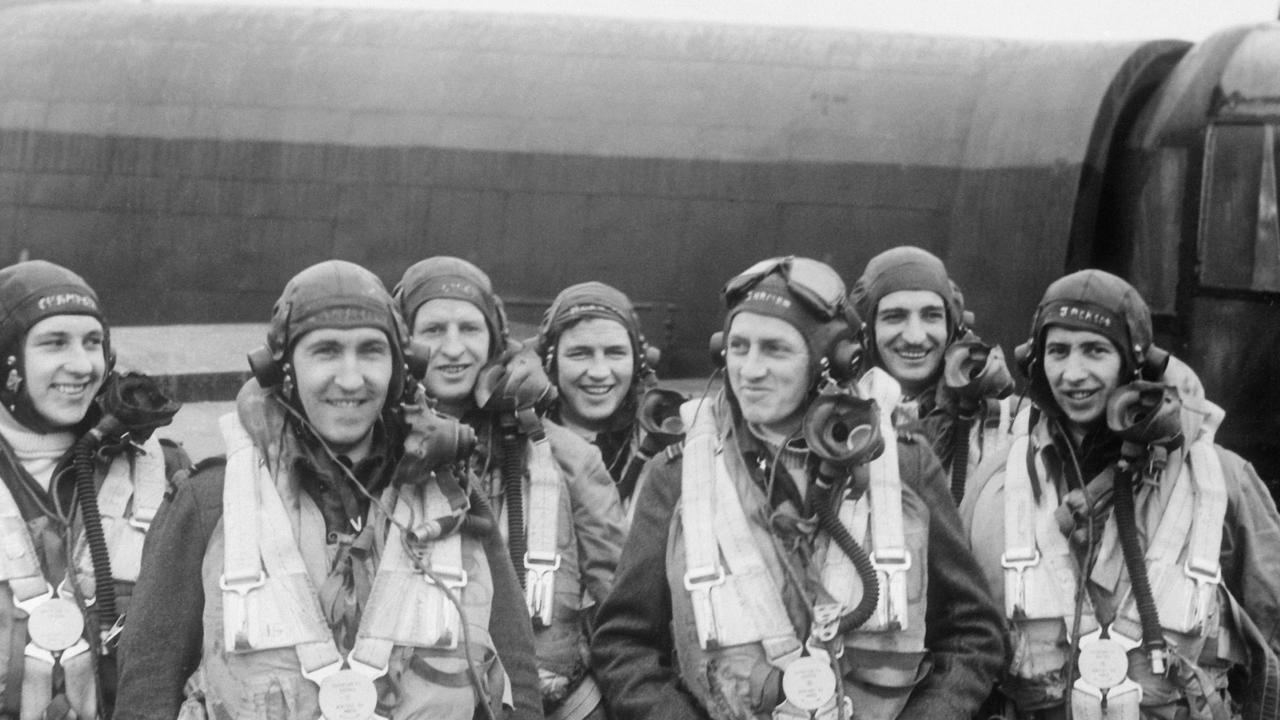 BINBROOK, ENGLAND. 1944-04-08. MEMBERS OF THE CREW OF A LANCASTER OF NO. 460 SQUADRON RAAF AT THE RAF STATION ON THEIR SECOND TOUR OF OPERATIONS. LEFT TO RIGHT: SERGEANT D. G. CHAMPKIN, RAF; 408034 FLYING OFFICER (FO) M. W. CARROLL DFC, FERNTREE GULLY, VIC; 414807 PILOT OFFICER T. J. LYNCH, TOOWOOMBA, QLD; 404467 FO H. R. HARRISON, LISMORE, NSW; 404507 SQUADRON LEADER E. G. D. JARMAN DFC, YEPPOON, QLD, CAPTAIN (THIRD FROM RIGHT); 411227 FO R. L. NEAL, GRENFELL, NSW; 404503 FO F. G. JACKSON DFC, LISMORE, NSW.