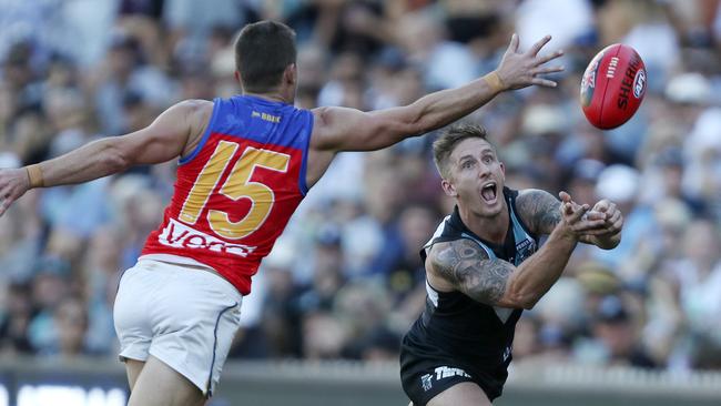 Hamish Hartlett gets his handpass away from Dayne Zorko. Picture SARAH REED