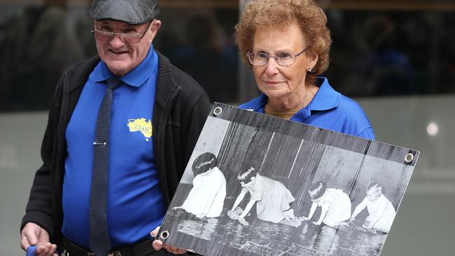 Protesters hold signs outside Melbourne County Court today. Picture: Michael Dodge/Getty Images